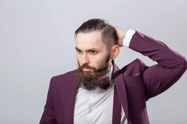 Pessoas, conceito elegante e de moda - Homem hipster barbudo atraente posando sobre fundo cinza — Fotografia de Stock