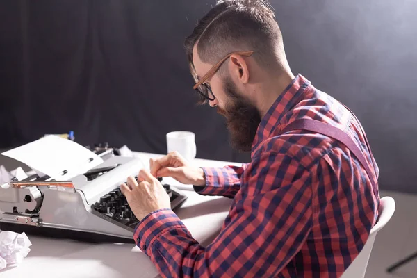 people, writer and hipster concept - young stylish writer working on typewriter