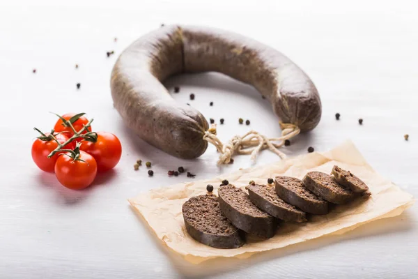 Food, meat and delicious concept - sausages made with horse meat with species and vegetables — Stock Photo, Image