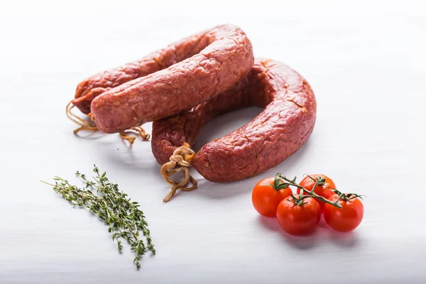 Food, national cuisine and delicious concept - Close up of traditional Kazakh horse meat sausage with tomato and cumin