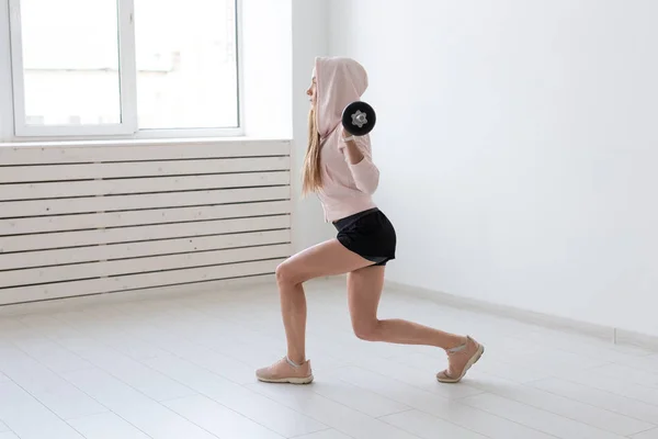 Esporte, fitness e conceito de pessoas - Bela jovem mulher exercitando agachamento com barra — Fotografia de Stock