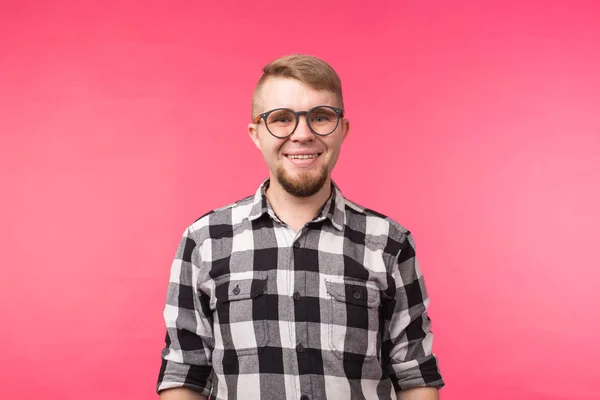 Portré a mosolygó szakállas ember a szemüvegek látszó-on fényképezőgép, elszigetelt, felett rózsaszín háttér — Stock Fotó