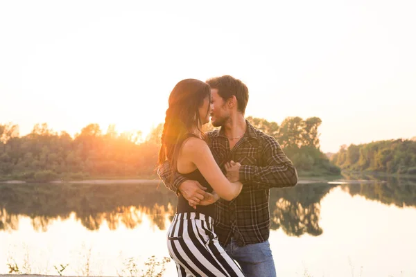 Concetto di danza romantica, sociale e popolare - giovane coppia che balla un tango o una bachata vicino al lago — Foto Stock