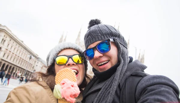 Resa i vinter och Italien koncept - glad ung par ta selfie foto med glass framför Milanos Duomo. — Stockfoto