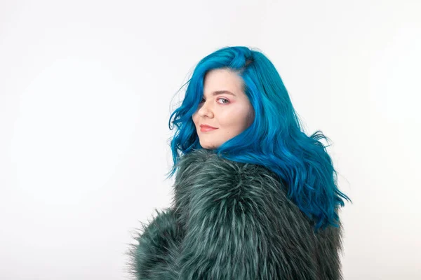 Animal protection, fashion and hair concept - beautiful girl with blue hair dressed in artificial fur coat standing on white background with copy space — Stock Photo, Image