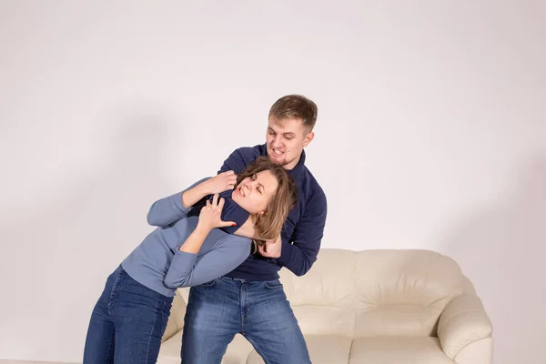 People, abuse and violence concept - agressive man strangling his wife — Stock Photo, Image