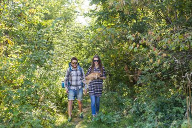Seyahat, Macera, zam, turizm ve doğa kavramı - turist çift ormanda yürüyüş kedi ile