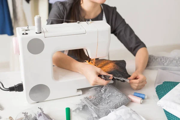 People, dressmaker, tailor and fashion concept - close up of young fashion designer in her showroom — Stock Photo, Image