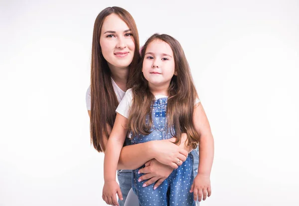 Szülői, családi és gyermek koncepció - portré egy anya és baba lány van móka és mosolyogva felett fehér háttér — Stock Fotó