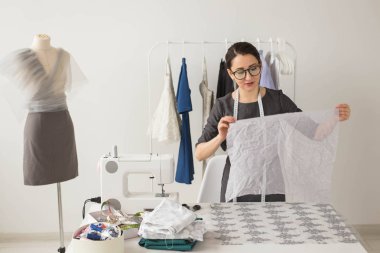Terzi, moda tasarımcısı ve terzi kavramı - genç kadın tasarımcı, bir elbise yaratma süreci