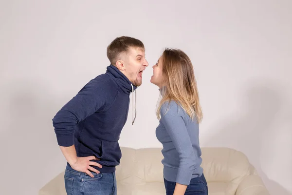 People, domestic violence and abuse concept - young couple arguing indoors — Stock Photo, Image