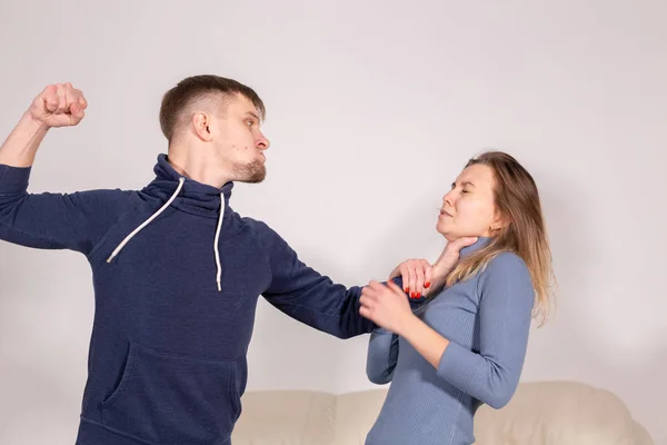 People and abuse concept - Portrait of angry young man try to hit the woman — Stock Photo, Image