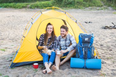 Kişi, turizm ve doğa kavramı - şirin çift sarı çadırda bir kedi ile oturan