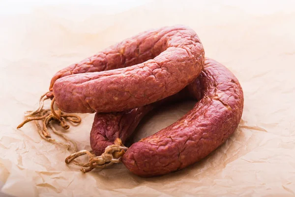 Food, meat and delicious concept - sausages made with horse meat on the table — Stock Photo, Image