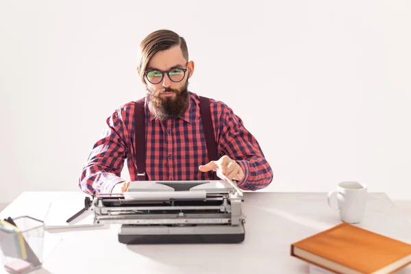 people, writer and hipster concept - young stylish writer working on typewriter
