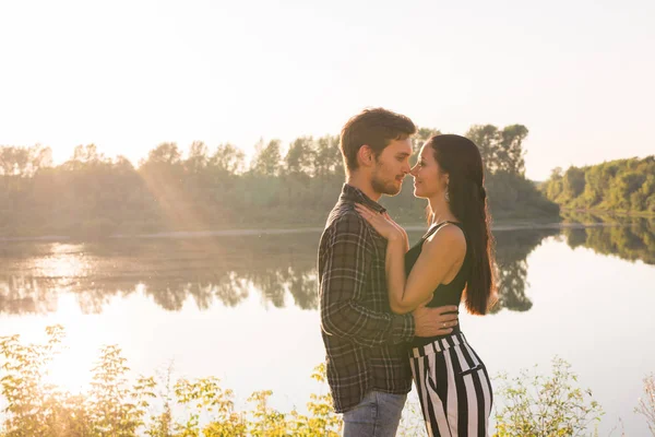 Persone, amore e concetto di natura Ritratto di giovane bella coppia che si abbraccia mentre si trova sopra lo sfondo della natura — Foto Stock