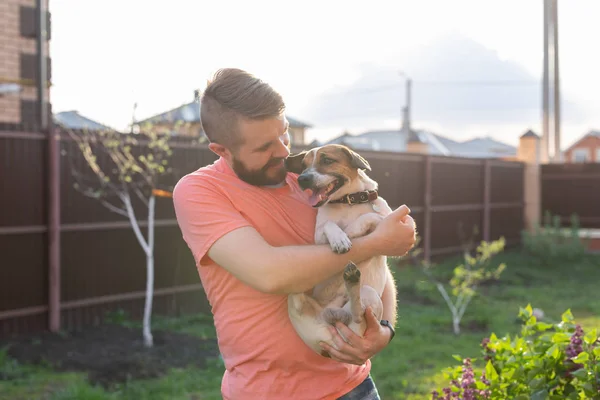 Man holding on hands his lovely jack russell terrier dog. — Stock Photo, Image