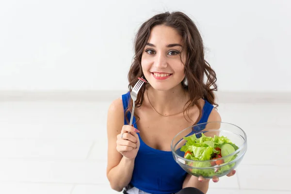 Alimentation, mode de vie sain, concept de personnes - Jeune femme mangeant de la salade et souriant — Photo
