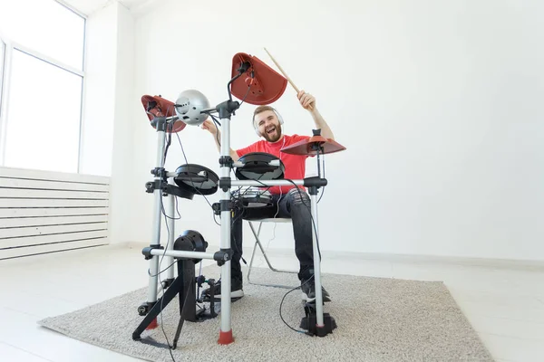 Concepto de personas, música y hobby - Hombre duro tocando en el kit de batería electrónica — Foto de Stock