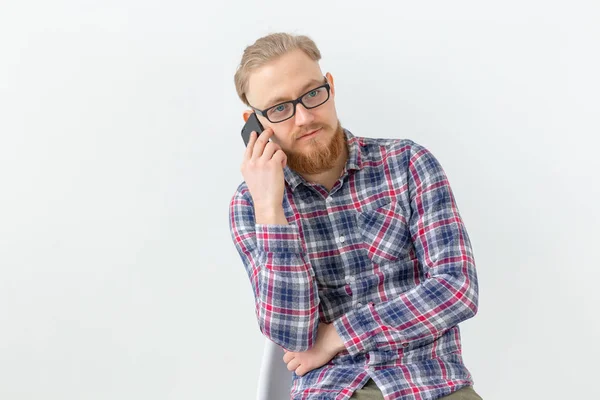 Szakállas csinos férfi beszél a telefon felett fehér háttér — Stock Fotó