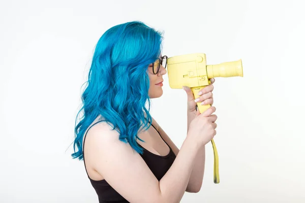 Persone, hobby e concetto di moda - Bella ragazza con i capelli blu tenere giallo fotocamera retrò su sfondo bianco — Foto Stock