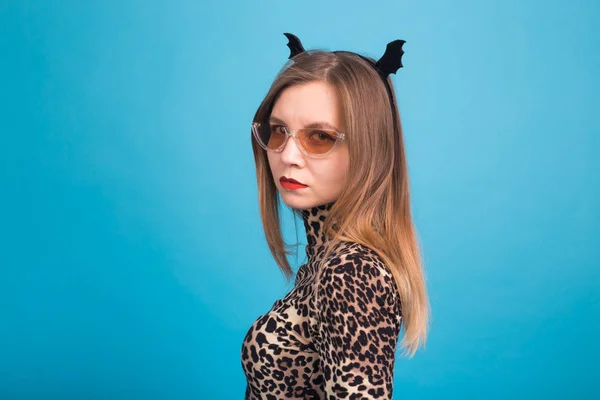 The evil woman with a waist bat on the head. Fancy dress for Halloween on blue background — Stock Photo, Image
