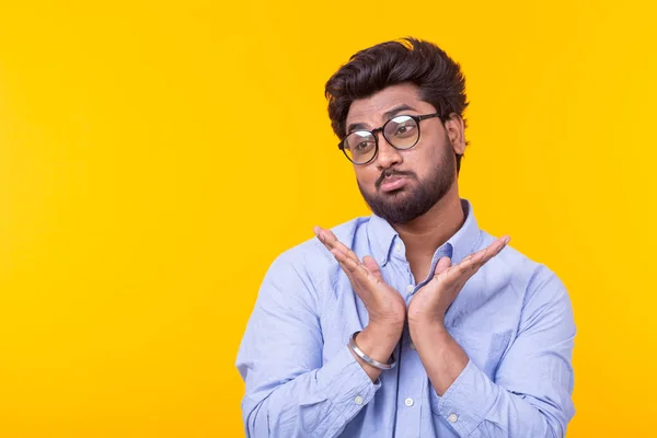 Jonge twijfel gemengde ras mannelijke student met bril en formele kleren poseren op een gele achtergrond met Kopieer ruimte — Stockfoto