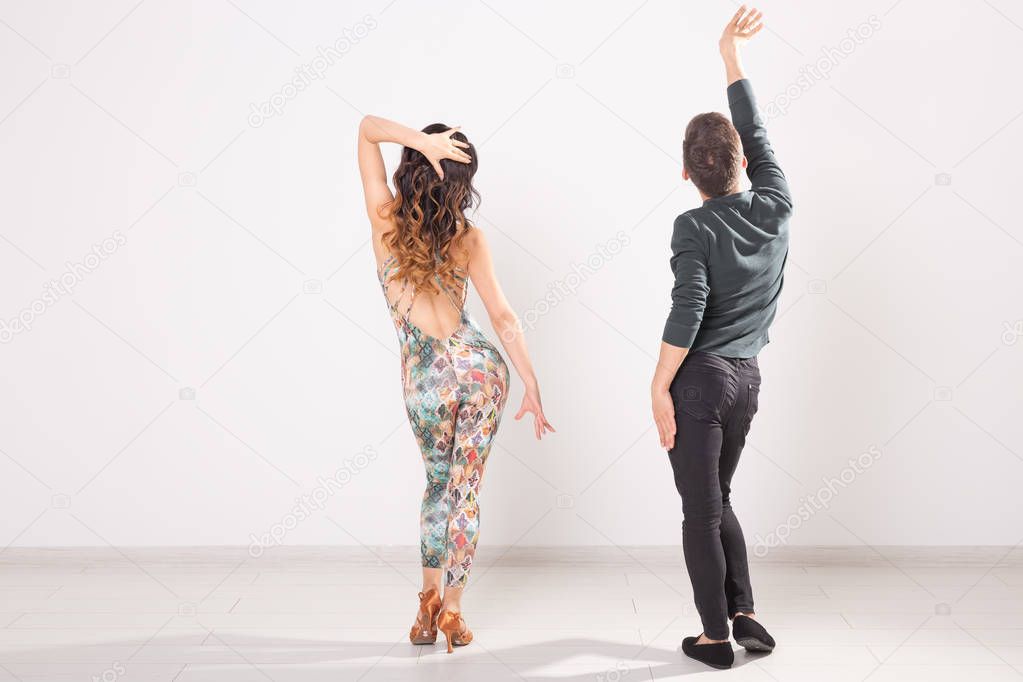 Social dance, kizomba, tango, salsa, people concept - beautiful couple dancing bachata on white background with copy space