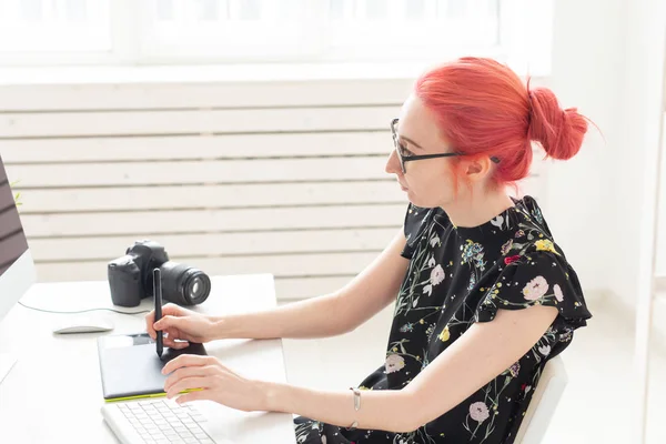 Creative, illustrator, graphic and people concept - Creative female businessman writing or drawing on graphic tablet while using laptop in office