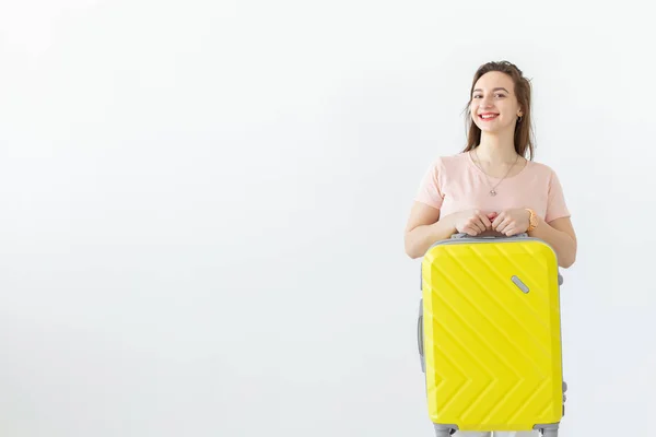 Reis-, reis-en vakantie concept-vrouw met haar gele koffer over witte achtergrond met Kopieer ruimte — Stockfoto