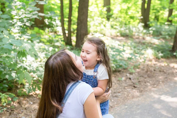 Family and nature concept - Young woman with little girl have fun outdoors — Stock Photo, Image