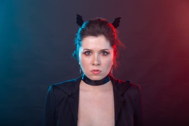 Cadılar Bayramı, tatil ve karnaval konsepti - ceket kadın ve gotik tarzı yarasa kulakları ile.