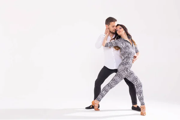 Young couple dancing social latin dance bachata, merengue, salsa. Two elegance pose on white background with copy space — Stock Photo, Image