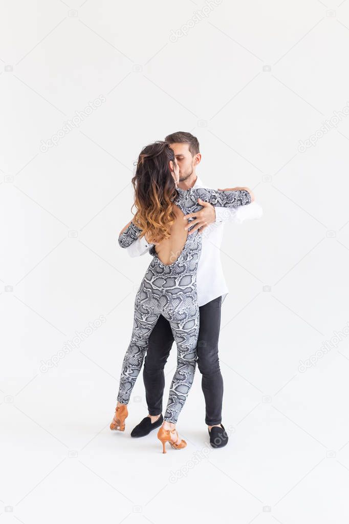 Social dance, bachata, kizomba, tango, salsa, people concept - Young couple dancing over white background with copy space