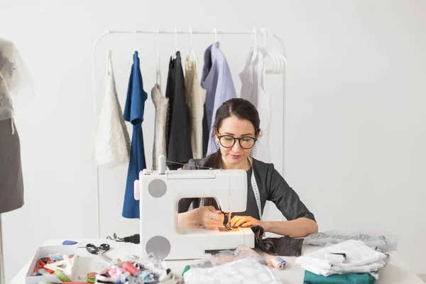 人, 裁缝, 裁缝和时尚概念-微笑的女性时装设计师使用缝纫机 — 图库照片