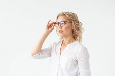 Beyaz arka plan üzerinde izole gözlük dokunmadan kötü görme ile konsantre güzel kadın Portresi