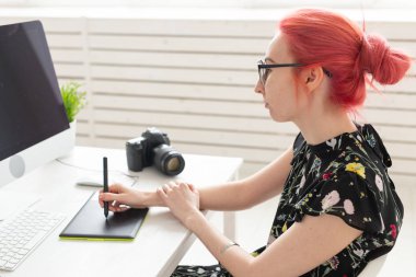 İş, tasarımcı ve animatör kavramı - pembe saçlı genç kadın illüstratör veya sanatçı grafik tablet çizer