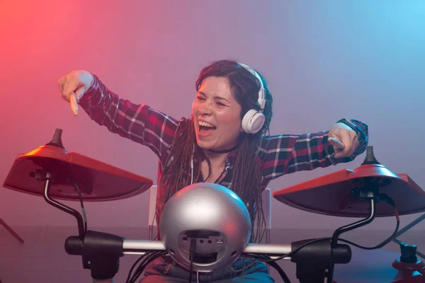 Emotions, music, hobbies and people concept - young woman playing the electronic drum set in studio — Stock Photo, Image