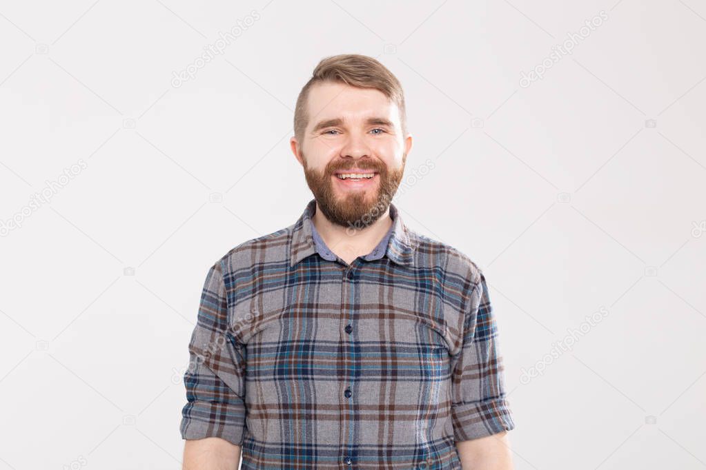 Handsome happy bearded man smiling and laughing on white background