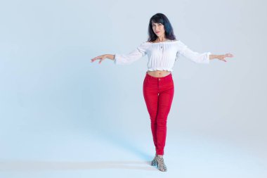 Latin dans, çağdaş dans, bachata solo ve cha-cha-cha kavramı - kopya alanı ile mavi arka plan üzerinde bir dans poz genç bir kadın salsa dansçı portresi