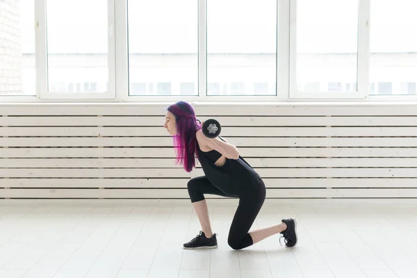 Fitness, deporte, concepto de personas - mujer joven en traje deportivo está en cuclillas con bar —  Fotos de Stock