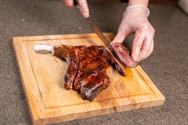 Comida, delicioso e conceito de artesanato - Homem cortando bife de cavalo — Fotografia de Stock
