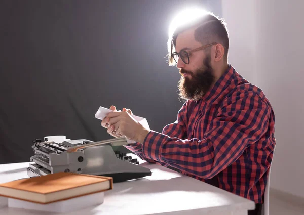 people, writer and hipster concept - young stylish writer working on typewriter
