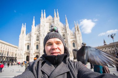 Seyahat, tatil ve kış tatil kavramı - mutlu adamı kabul selfie fotoğraf komik güvercinler ile Duomo Milan Katedrali önünde