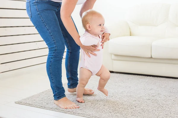 Little baby girl first steps with the help of mom — Stock Photo, Image