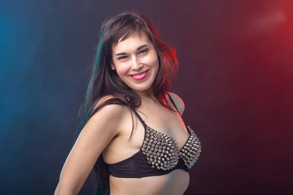 Alluring young beautiful brunette woman in a underwear posing on a dark background. Concept of seduction and sexual attractiveness — Stock Photo, Image