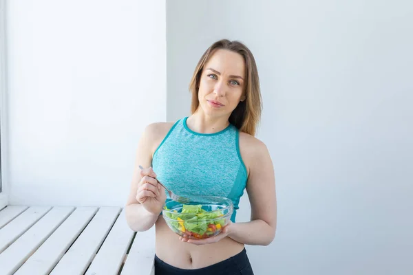 Estilo de vida saudável, fitness e conceito de dieta - salada dietética e mulher em roupas esportivas — Fotografia de Stock