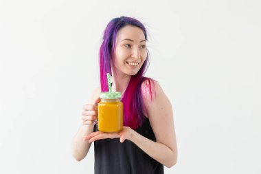 Renkli saç içecekler meyve yüzlü ile Sevimli genç karışık ırk hipster kız kopya alanı ile beyaz bir arka plan üzerinde bir yoga sınıfı başlamadan önce. Sağlıklı yaşam tarzı kavramı. Copyspase.