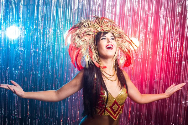 Carnival, belly dance and holiday concept - Beautiful female samba dancer wearing gold costume and smiling