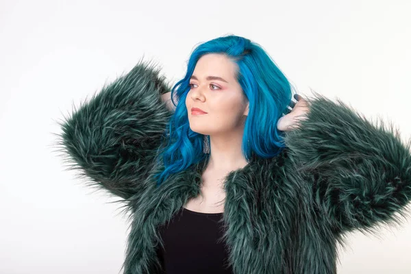Proteção animal, moda e conceito de cabelo - menina bonita com cabelo azul vestido com casaco de pele artificial em pé sobre fundo branco — Fotografia de Stock